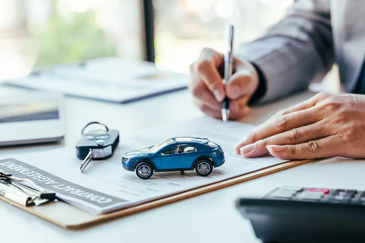 Man signing car insurance document or lease paper. Writing signa